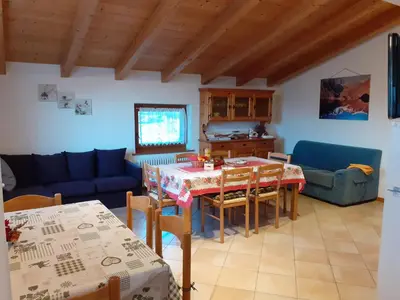 a living room with a table and a couch at Appartamenti Rumo in Rumo