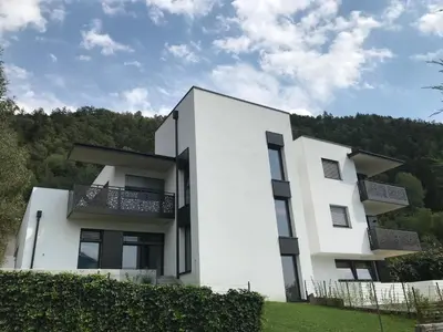 a white house with trees in the background at Apartment42 in Bressanone