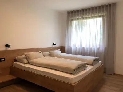 a bed in a room with a window at Apartment42 in Bressanone