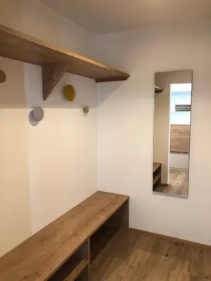 a room with a wooden bench and a mirror at Apartment42 in Bressanone
