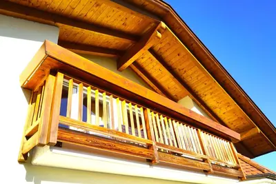 a wooden balcony on the side of a house at Unterbi Apartments in Appiano sulla Strada del Vino