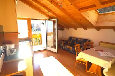a living room with a table and a couch at Unterbi Apartments in Appiano sulla Strada del Vino