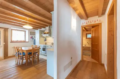 a kitchen and dining room with a table and chairs at Casa Roberto in Moena