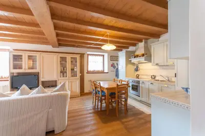a kitchen and dining room with a table and chairs at Casa Roberto in Moena