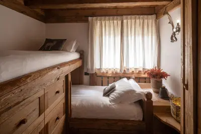 a bedroom with a bed and a window at Cortina Lodge Stunning View R&R in Cortina dʼAmpezzo