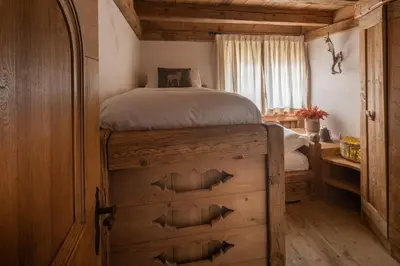 a bedroom with a bed in a log cabin at Cortina Lodge Stunning View R&R in Cortina dʼAmpezzo