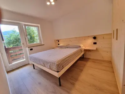 a bedroom with a bed and a window at Val Fassa in Campitello di Fassa