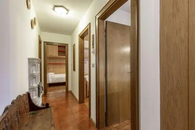 a hallway with a door leading to a bedroom at Val Fassa in Campitello di Fassa