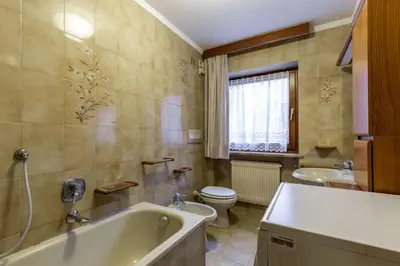 a bathroom with a tub and a toilet and a sink at Val Fassa in Campitello di Fassa