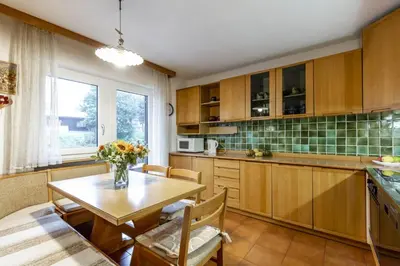 a kitchen with a table and a dining room at Val Fassa in Campitello di Fassa