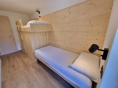 a small room with a bunk bed in a room at Val Fassa in Campitello di Fassa