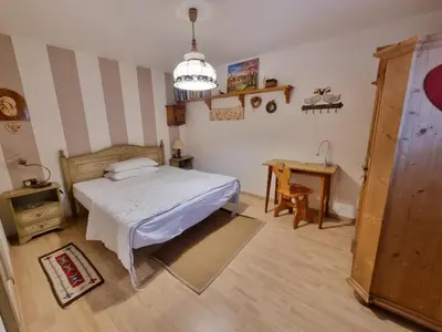 a bedroom with a bed and a table and a desk at Salin in Campitello di Fassa