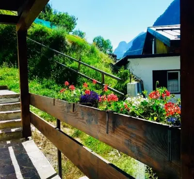 a wooden fence with flowers in a garden at Salin in Campitello di Fassa