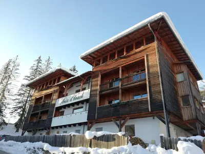 an apartment building in the snow at Aria d'Bosch in Badia
