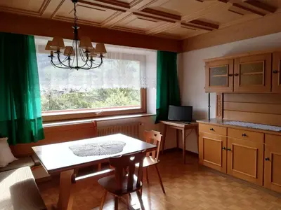 a kitchen with a table and a window at Aria d'Bosch in Badia