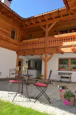 a wooden pavilion with a table and chairs under it at Bergidyll an der Lane - Pfunders in Fundres