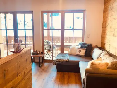 a living room with a couch and some windows at Bergidyll an der Lane - Pfunders in Fundres