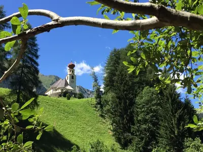 a lighthouse on top of a hill with trees at Bergidyll an der Lane - Pfunders in Fundres