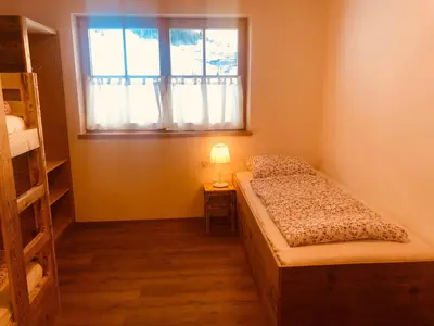 a small bedroom with a bed and a window at Bergidyll an der Lane - Pfunders in Fundres