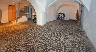 a room with a tile floor with a motorcycle in it at Casa Seler - Appartamento verde in Predazzo