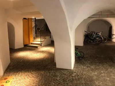 a hallway with stairs and bikes parked in a building at Casa Seler - Appartamento rosso in Predazzo