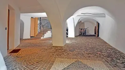 a hallway with a tile floor and a staircase at Casa Seler - Appartamento rosso in Predazzo
