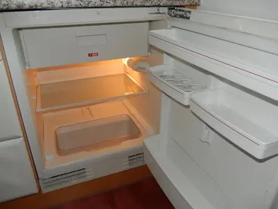 an empty refrigerator with its door open at Garni Sonnleiten in Tirolo