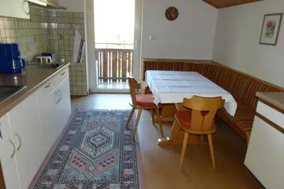 a kitchen with a table and some chairs and a table and a table at Garni Sonnleiten in Tirolo