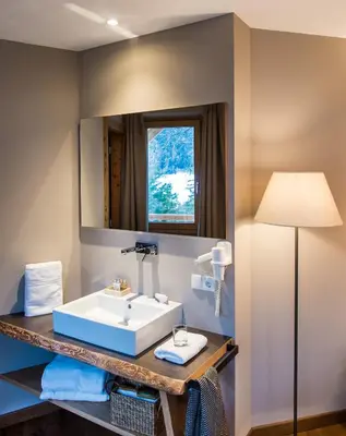 a bathroom with a sink and a mirror at Hotel Paradies in Tires