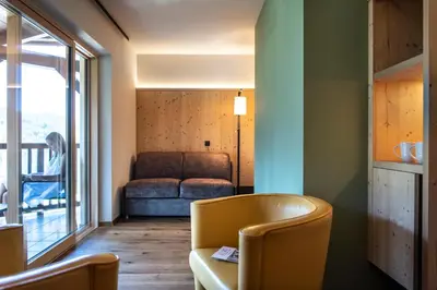 a living room with a couch and a table at Hotel Paradies in Tires