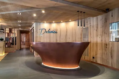 a restaurant with a large copper bowl on the wall at Hotel Garni Dolomieu in Selva di Val Gardena