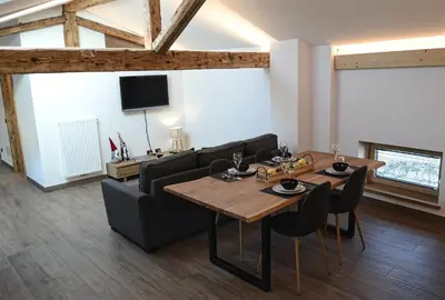 a living room with a table and a couch at Apartment El Molin - Alpe Cermis Dolomites in Cavalese