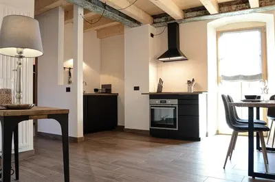 a kitchen with a table and a stove top oven at Apartment El Molin - Alpe Cermis Dolomites in Cavalese