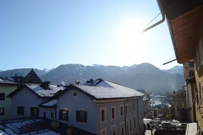 a group of buildings with mountains in the background at Apartment El Molin - Alpe Cermis Dolomites in Cavalese