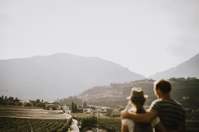 a man and a woman standing on top of a hill at Bäcksteinerhof in Merano