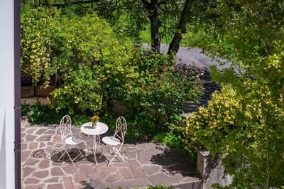 a table and chairs sitting on a stone patio at Haus Bellutti in Termeno