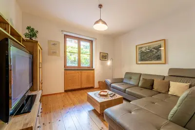 a living room with a couch and a flat screen tv at Haus Bellutti in Termeno