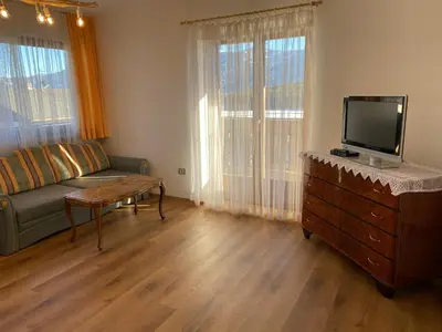 a living room with a couch and a flat screen tv at Haus Pfalzen - Casa Falzes in Falzes