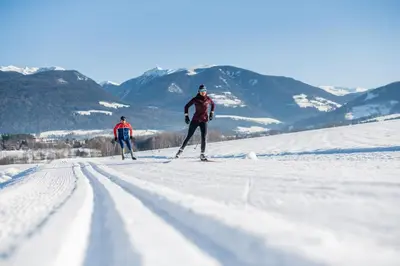 two people cross country skiing on a snow covered slope at Haus Pfalzen - Casa Falzes in Falzes