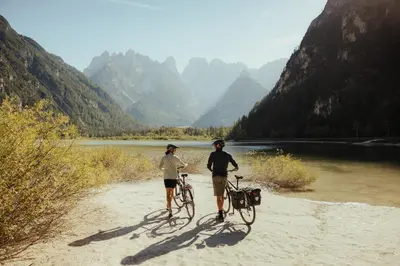 two people standing with bikes on a dirt path next to a river at Haus Pfalzen - Casa Falzes in Falzes
