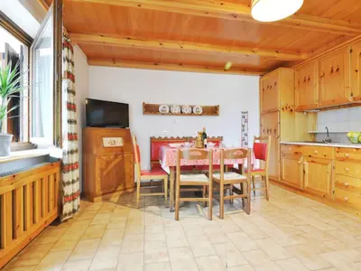 a kitchen and dining room with a table and chairs at Apartment Villaggio Ladino by Interhome in Mazzin