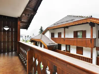 a balcony of a house with a wooden railing at Apartment Villaggio Ladino by Interhome in Mazzin