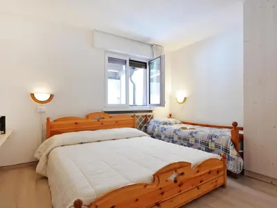 a bedroom with two beds and a window at Apartment Des Alpes-13 by Interhome in Canazei