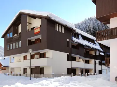 a building with a balcony on the side of it at Apartment Des Alpes-13 by Interhome in Canazei