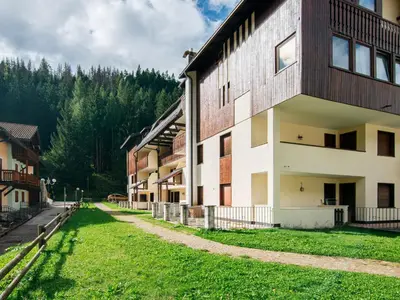 a group of houses with mountains in the background at Apartment Des Alpes-13 by Interhome in Canazei