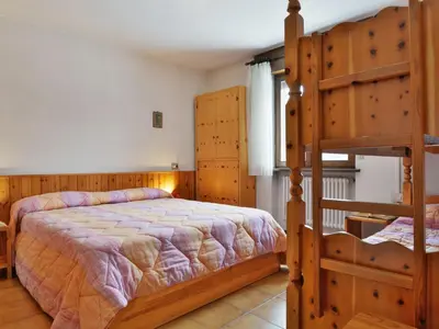 a bedroom with two bunk beds and a bed at Apartment Des Alpes-14 by Interhome in Canazei