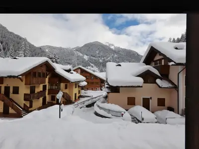 a group of buildings with snow on the roofs at Apartment Des Alpes-14 by Interhome in Canazei
