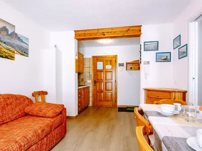a kitchen with an orange chair and a sink at Apartment Ciampac by Interhome in Alba di Canazei