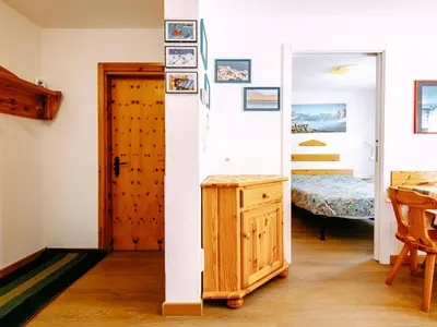 a room with a door and a bedroom with a bed at Apartment Ciampac by Interhome in Alba di Canazei