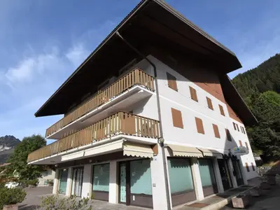 a building with a balcony on the side of it at Apartment Condominio al Parco-5 by Interhome in Canazei